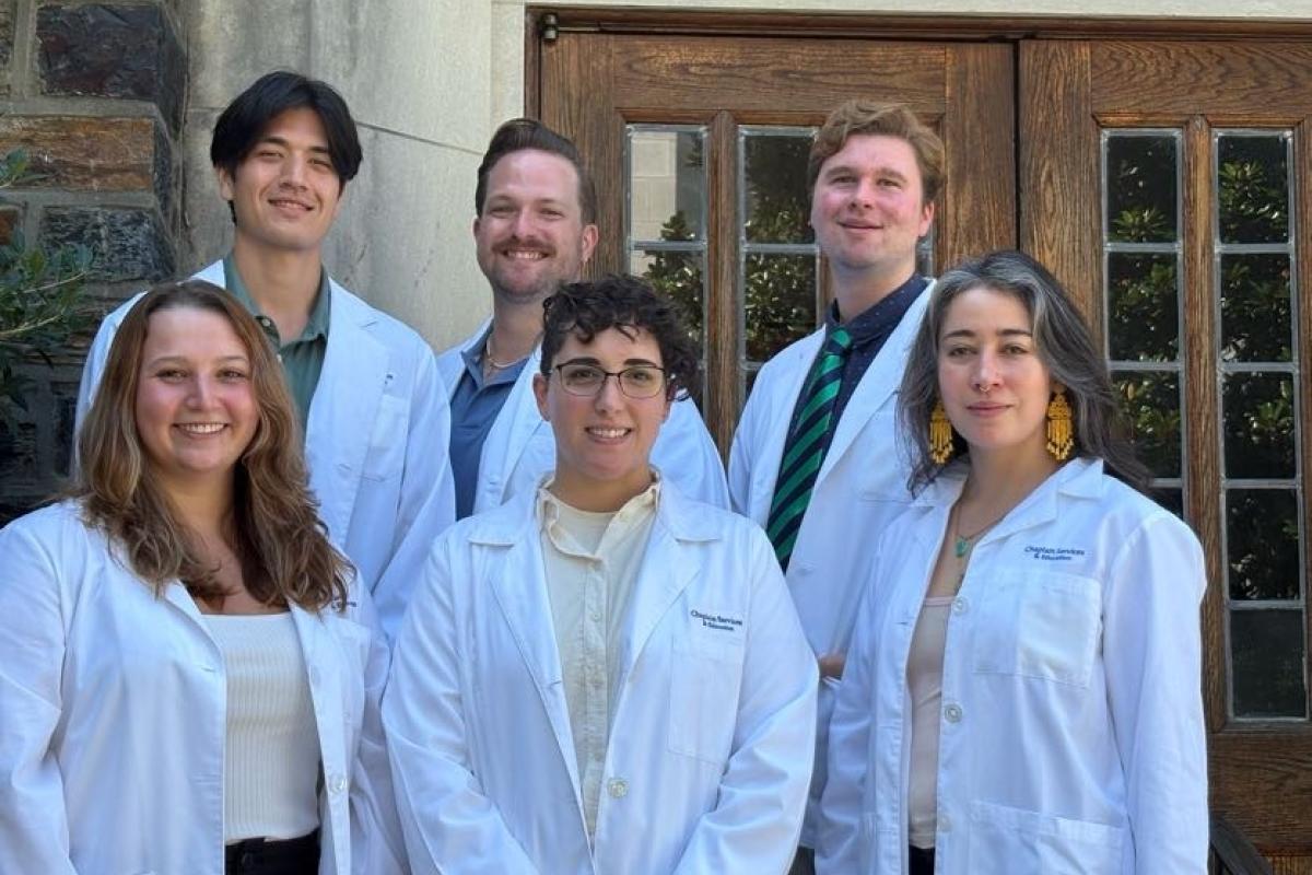 Six residents standing in lab coats